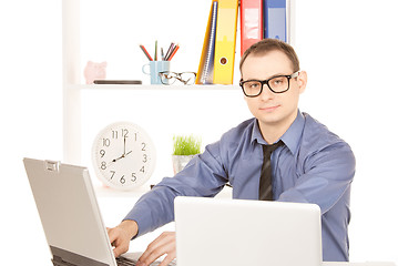 Image showing businessman with laptop computer in office