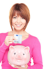 Image showing lovely woman with piggy bank and money