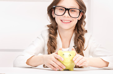 Image showing little girl with piggy bank