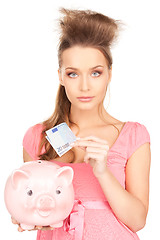 Image showing lovely woman with piggy bank and money