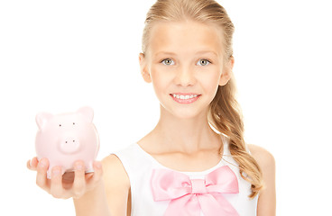 Image showing lovely teenage girl with piggy bank