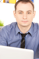 Image showing businessman with laptop computer in office