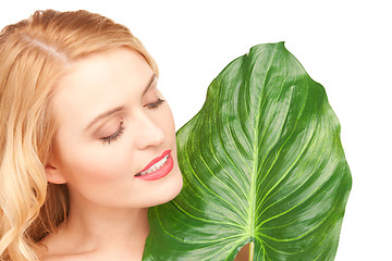 Image showing woman with green leaf over white