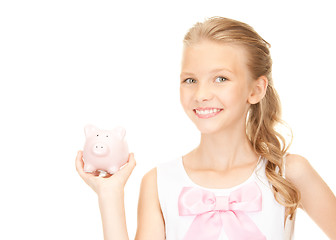 Image showing lovely teenage girl with piggy bank