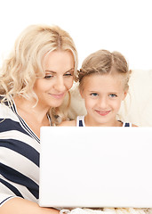 Image showing happy mother and child with laptop computer