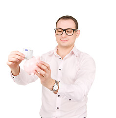 Image showing businessman with piggy bank and money