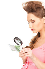 Image showing woman with magnifying glass and money