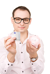 Image showing businessman with piggy bank and money