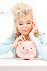 Image showing lovely woman with piggy bank