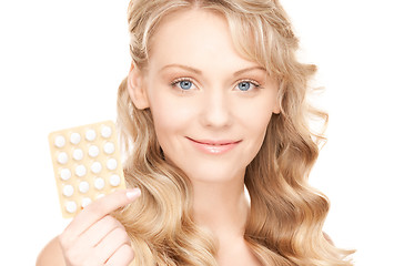 Image showing young woman with pills