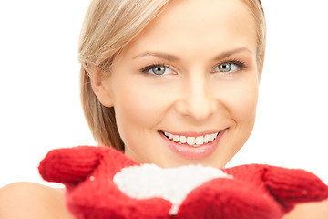 Image showing beautiful woman in red mittens with snow