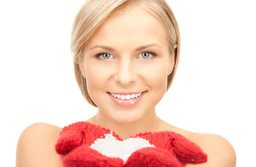 Image showing beautiful woman in red mittens with snow