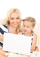 Image showing happy mother and child with laptop computer