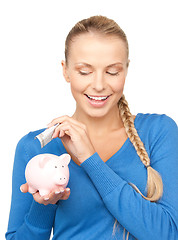 Image showing lovely woman with piggy bank and money