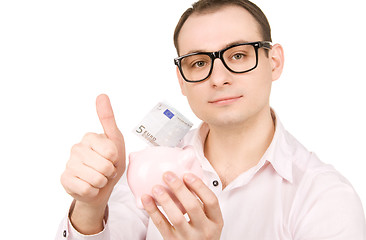 Image showing businessman with piggy bank and money