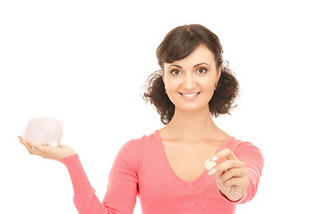 Image showing lovely woman with piggy bank and money