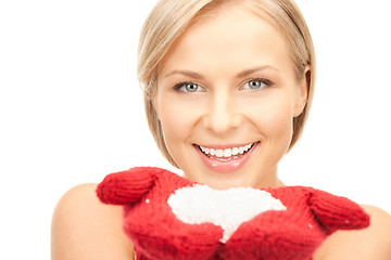 Image showing beautiful woman in red mittens with snow