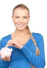 Image showing lovely woman with piggy bank and money