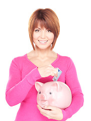 Image showing lovely woman with piggy bank and money