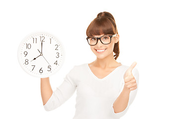 Image showing woman holding big clock