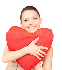Image showing woman with red heart-shaped pillow over white 