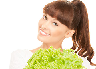 Image showing beautiful housewife with lettuce over white