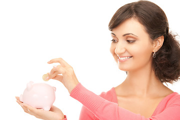 Image showing lovely woman with piggy bank and money