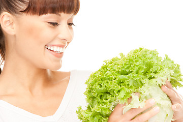 Image showing beautiful housewife with lettuce over white