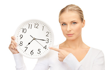 Image showing woman holding big clock