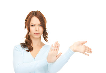 Image showing businesswoman working with something imaginary