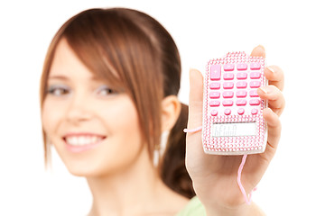 Image showing lovely teenage girl with calculator