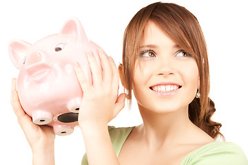 Image showing lovely teenage girl with piggy bank