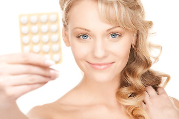 Image showing young woman with pills