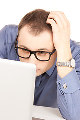 Image showing businessman with laptop computer in office