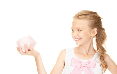 Image showing lovely teenage girl with piggy bank