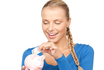 Image showing lovely woman with piggy bank and money