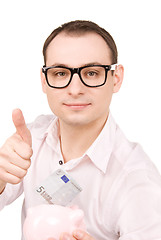 Image showing businessman with piggy bank and money