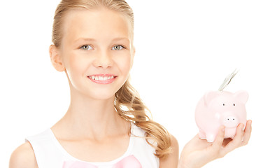 Image showing lovely teenage girl with piggy bank and money