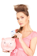 Image showing lovely woman with piggy bank and money