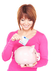 Image showing lovely woman with piggy bank and money