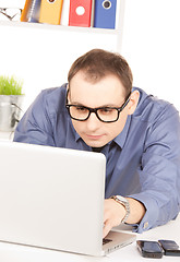 Image showing businessman with laptop computer in office