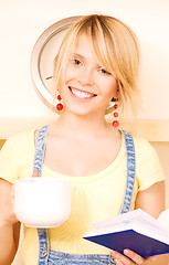 Image showing teenage girl with book and mug