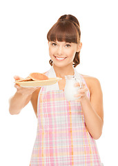 Image showing housewife with milk and cookies