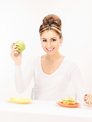 Image showing woman with green apple and sandwich
