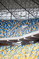 Image showing Tiered seats sit empty in large sports stadium