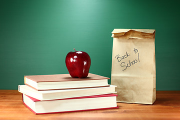 Image showing Books, Apple and Lunch on Teacher Desk