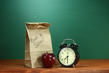 Image showing School Lunch, Apple and Clock on Desk at School