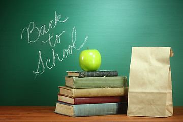 Image showing Books, Apple and Lunch on Teacher Desk