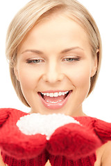 Image showing beautiful woman in red mittens with snow