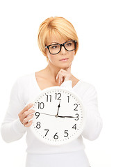 Image showing woman holding big clock